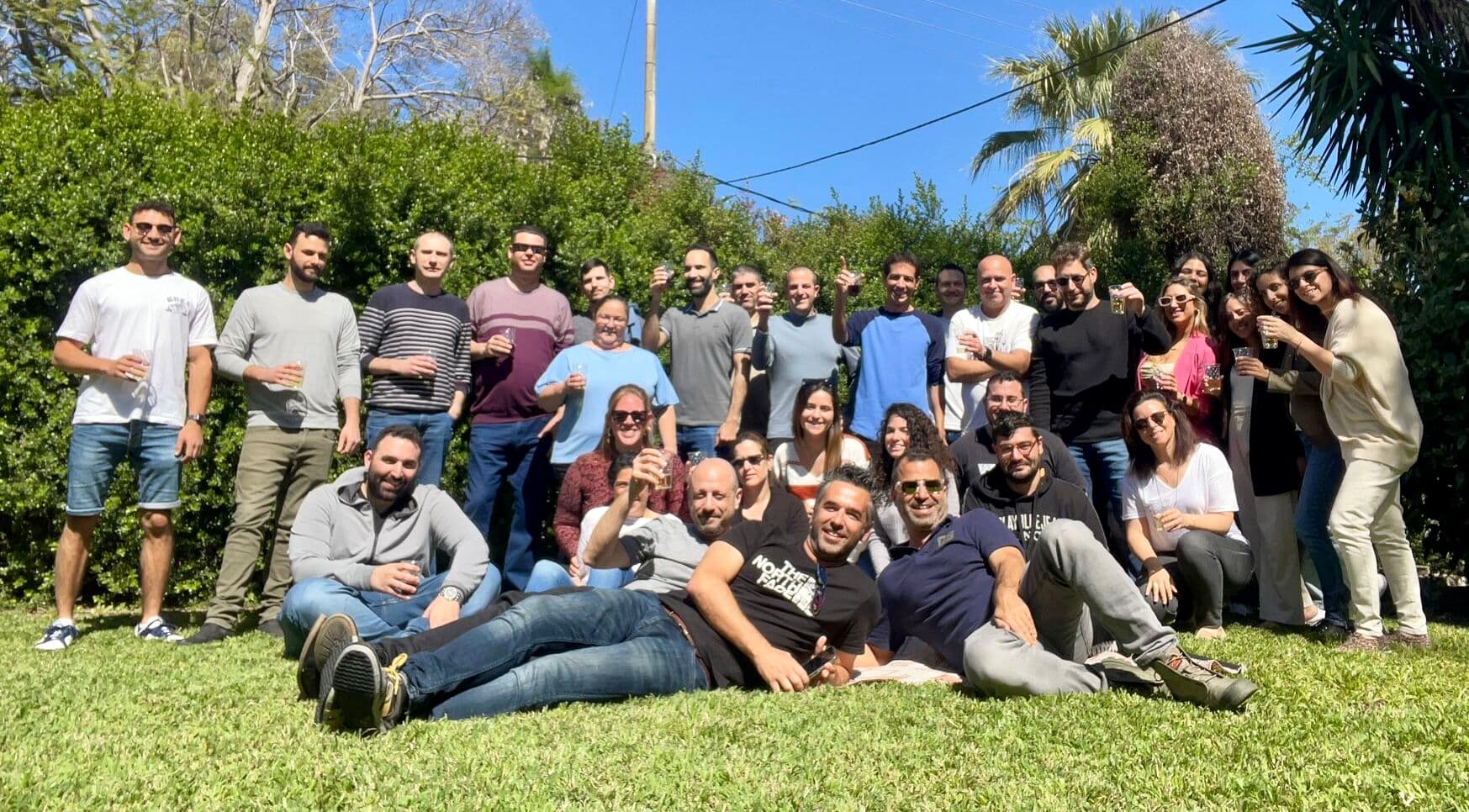 Tomax team celebrating together outdoors