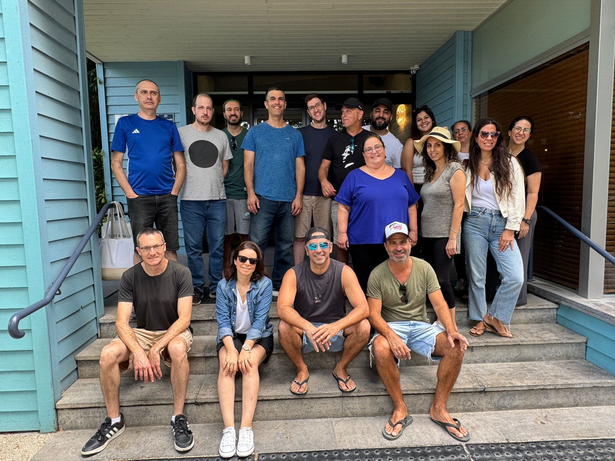 Tomax team posing together on a staircase
